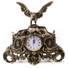 A large fireplace clock with an eagle