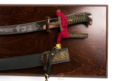 Polish Hussar saber from the first half 17th century, chrome version with scabbard on a hanging table - replica